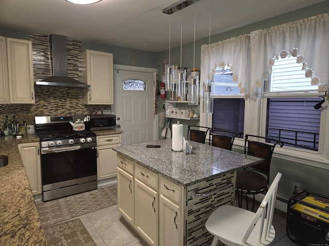 232 Hillside Ave, Waterbury, CT 06710 - kitchen featuring appliances with stainless steel finishes, wall chimney exhaust hood, light stone counters, backsplash, and light tile patterned flooring