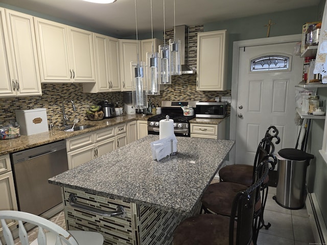 kitchen featuring a kitchen island, stone countertops, appliances with stainless steel finishes, sink, and wall chimney exhaust hood