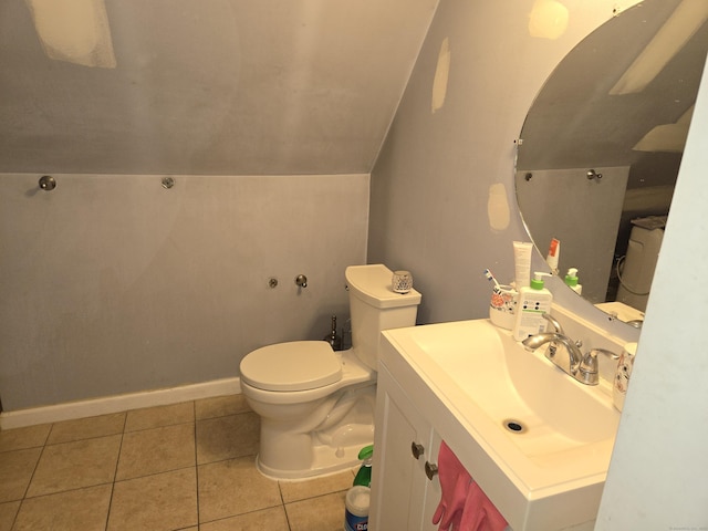 bathroom with vanity, tile patterned flooring, vaulted ceiling, and toilet