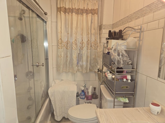 232 Hillside Ave, Waterbury, CT 06710 - bathroom with tile walls, combined bath / shower with glass door, and toilet