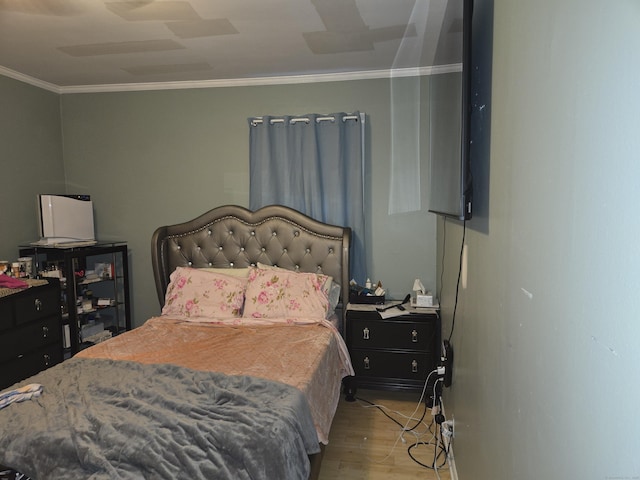 bedroom with crown molding, light hardwood / wood-style flooring, and ceiling fan