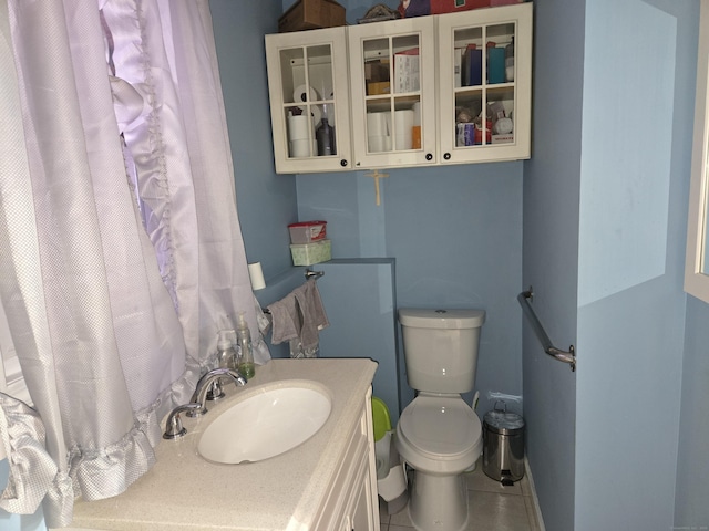 bathroom with vanity, tile patterned flooring, and toilet