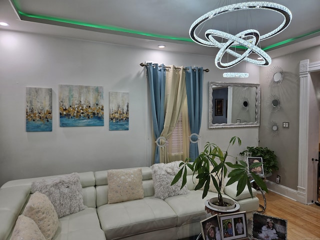 living room with hardwood / wood-style flooring and a notable chandelier