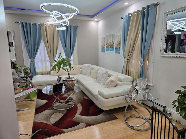 living room with hardwood / wood-style flooring and a notable chandelier