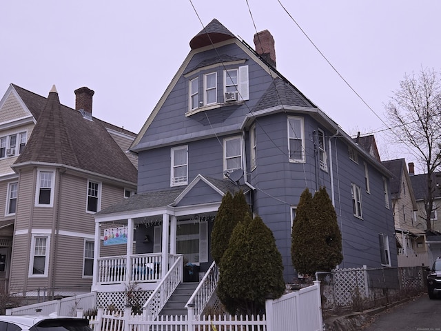 232 Hillside Ave, Waterbury, CT 06710 - view of front of home featuring a porch, a fenced front yard, and a chimney