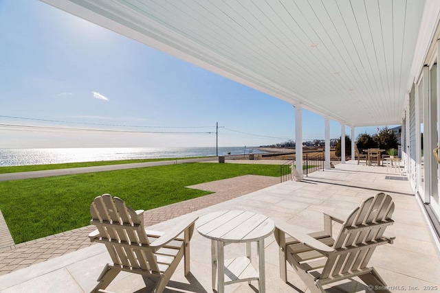 view of patio featuring a water view and outdoor dining space