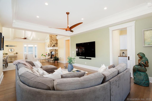 464 Park Blvd, Stratford, CT 06615 - living room with a fireplace, wood finished floors, a ceiling fan, ornamental molding, and a raised ceiling