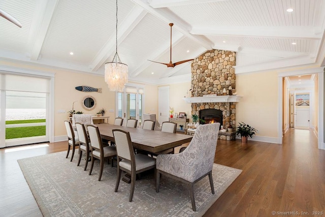 464 Park Blvd, Stratford, CT 06615 - dining space featuring vaulted ceiling with beams, baseboards, wood finished floors, and a stone fireplace