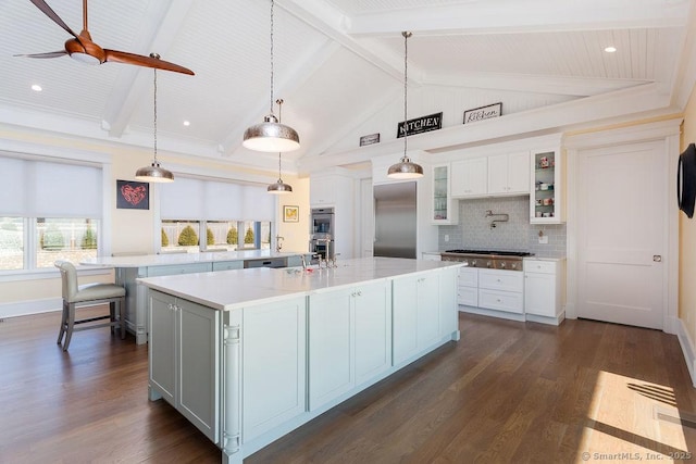 464 Park Blvd, Stratford, CT 06615 - kitchen featuring stainless steel appliances, a spacious island, light countertops, tasteful backsplash, and dark wood finished floors