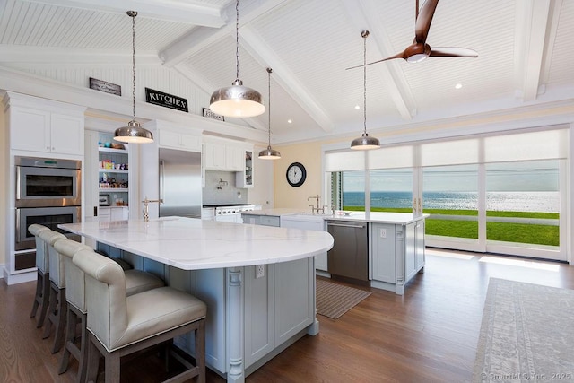 464 Park Blvd, Stratford, CT 06615 - kitchen with lofted ceiling with beams, a spacious island, dark wood-style floors, and stainless steel appliances