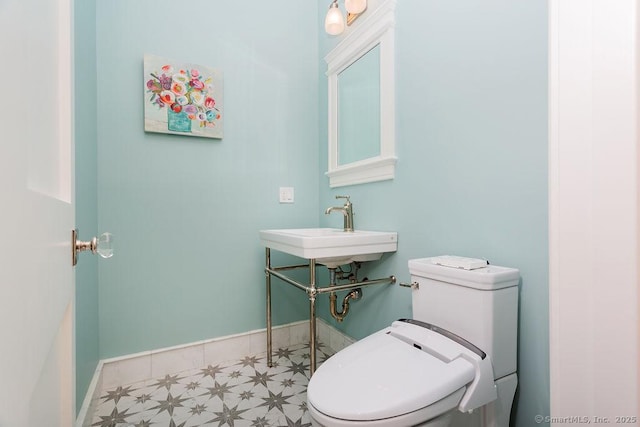 464 Park Blvd, Stratford, CT 06615 - half bath featuring toilet, baseboards, a sink, and tile patterned floors
