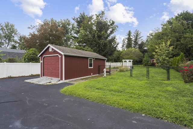 view of outbuilding featuring a garage and a yard