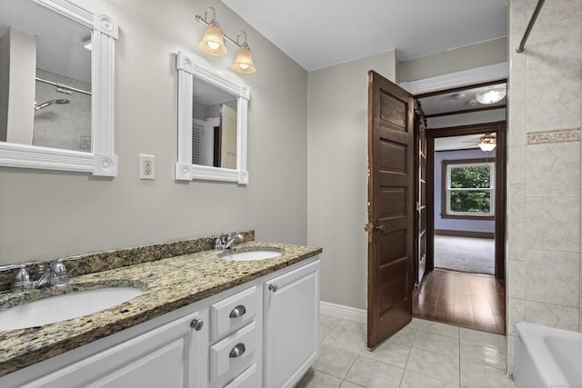 bathroom with ceiling fan, tile patterned floors,  shower combination, and vanity