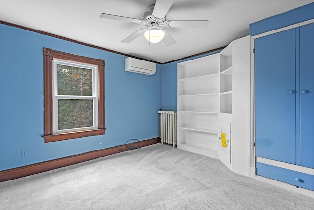 carpeted empty room with ceiling fan, a wall mounted air conditioner, radiator, and ornamental molding