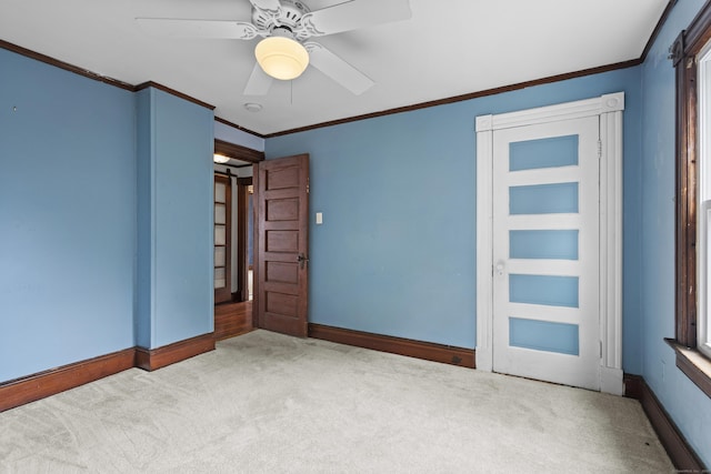 unfurnished bedroom with light carpet, ornamental molding, and ceiling fan