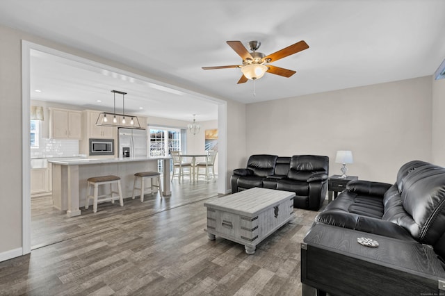 living room with hardwood / wood-style flooring and ceiling fan