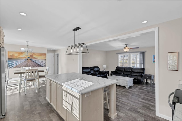 kitchen featuring pendant lighting, dark hardwood / wood-style floors, and a kitchen island