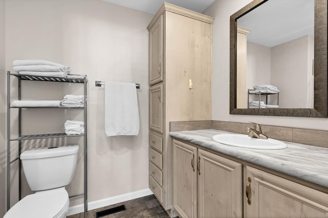 bathroom featuring vanity and toilet