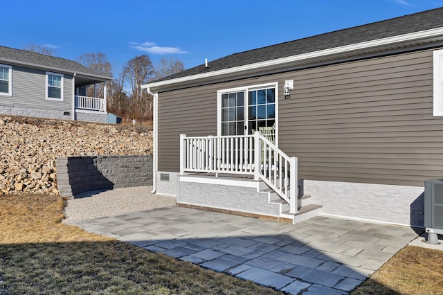 property entrance with central AC and a patio