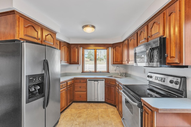 kitchen featuring light tile patterned flooring, appliances with stainless steel finishes, and sink