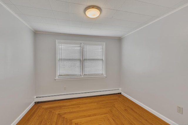 spare room with parquet flooring, ornamental molding, and baseboard heating