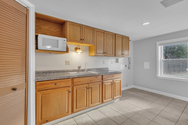 kitchen with sink and light tile patterned floors