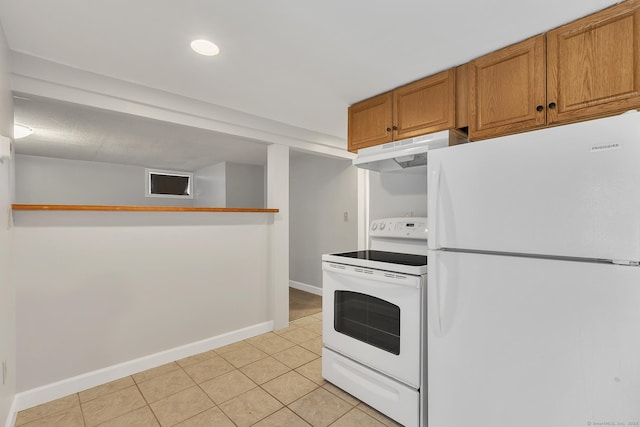 kitchen with white appliances and light tile patterned floors