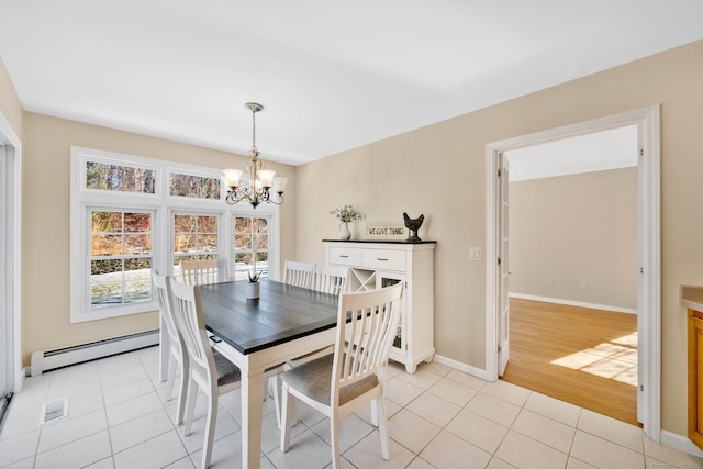 tiled dining area with baseboard heating and an inviting chandelier