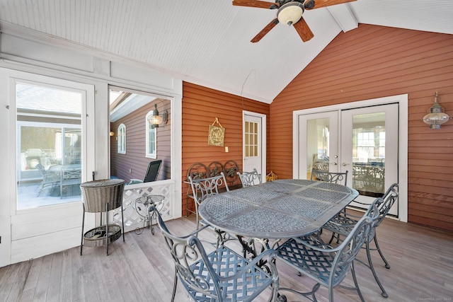 sunroom with french doors, ceiling fan, a healthy amount of sunlight, and lofted ceiling with beams