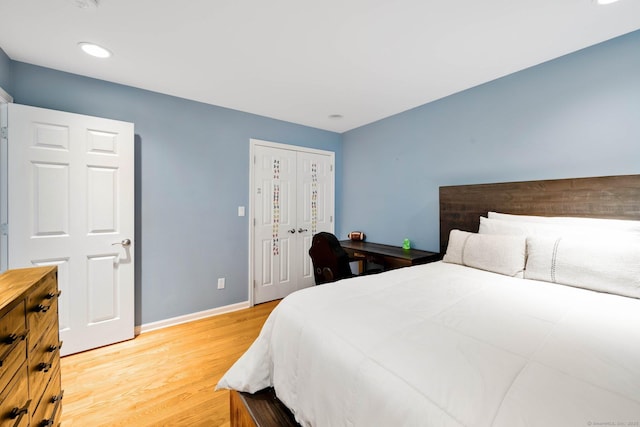 bedroom featuring light hardwood / wood-style floors and a closet