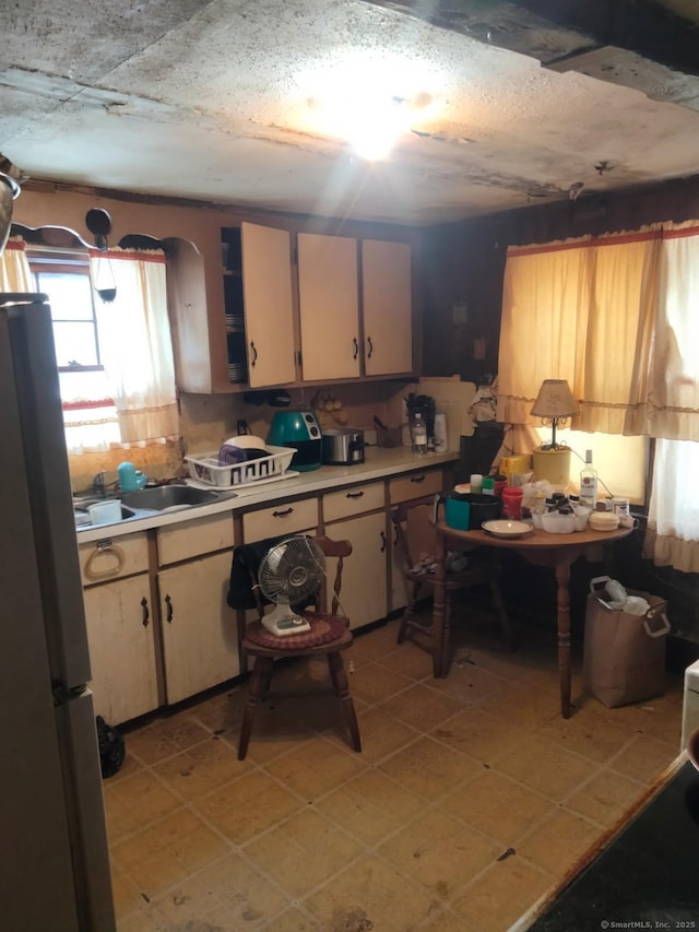 kitchen with sink and stainless steel fridge