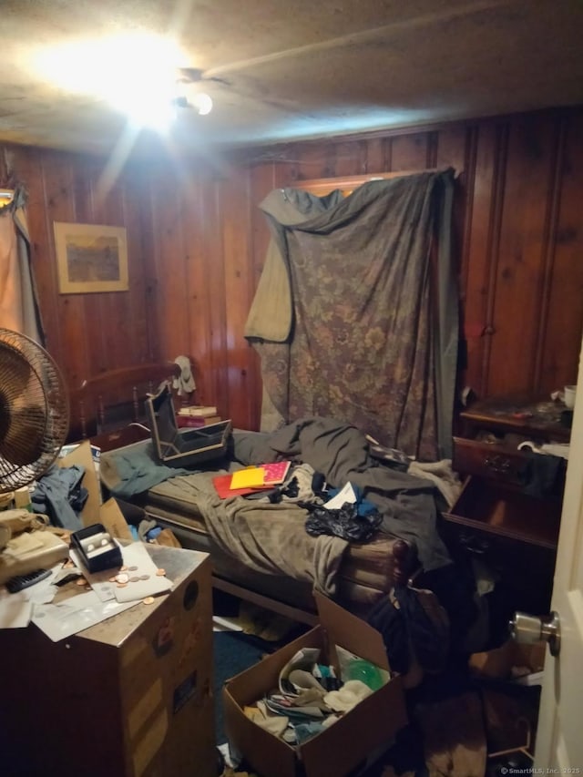 bedroom with wood walls