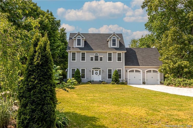 colonial-style house with a garage and a front lawn