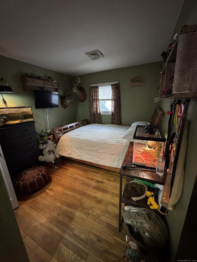 bedroom with hardwood / wood-style flooring