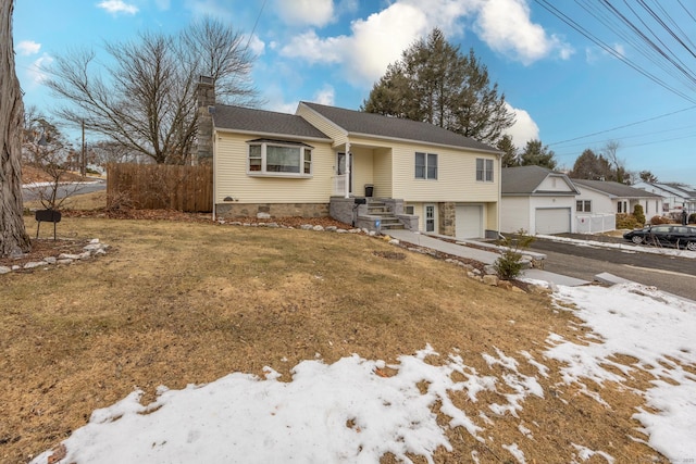 view of front of home with a garage and a yard