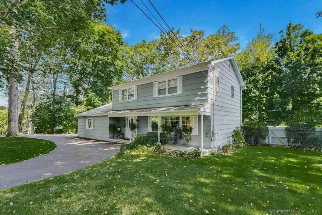 view of front facade with a front yard and covered porch