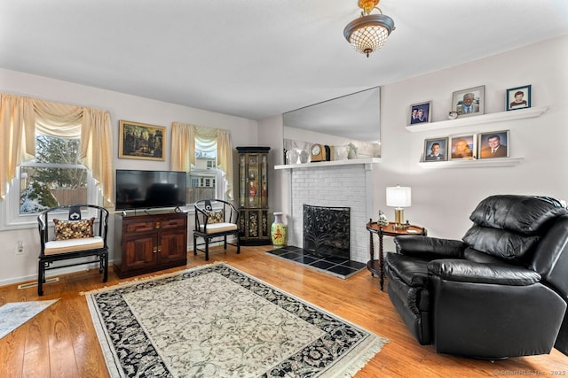 living area with a fireplace and wood finished floors