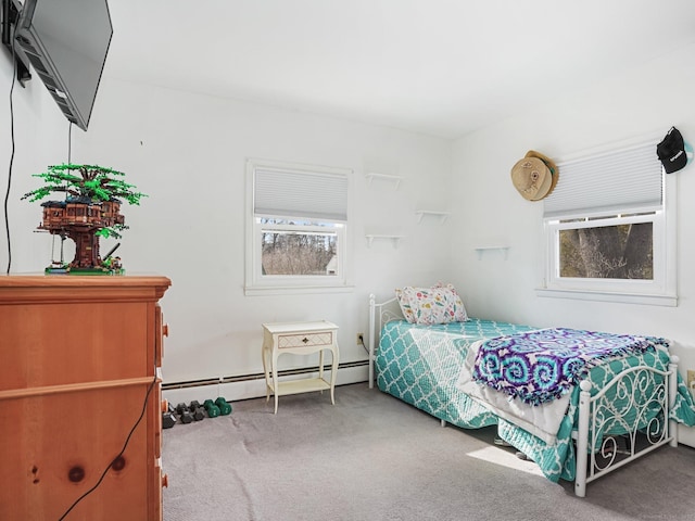 bedroom with a baseboard heating unit and carpet floors