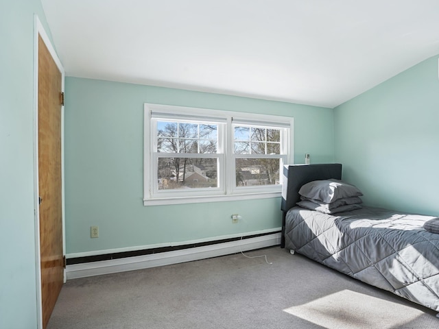 unfurnished bedroom featuring a baseboard heating unit and light carpet