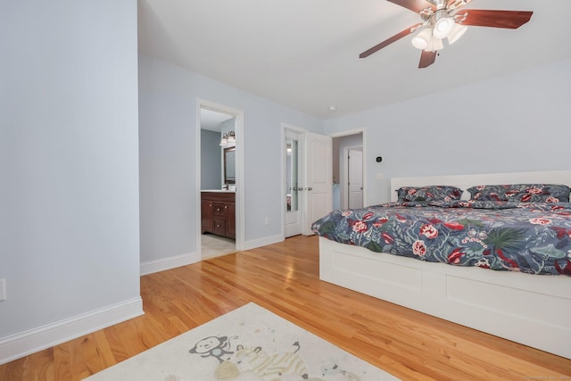 bedroom featuring hardwood / wood-style floors, ensuite bath, and ceiling fan