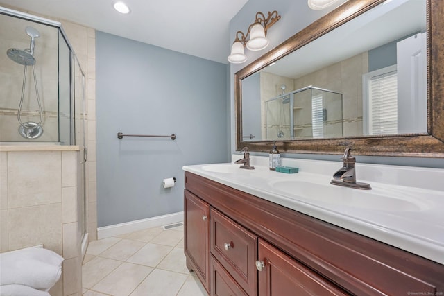 bathroom with tile patterned flooring, vanity, and an enclosed shower