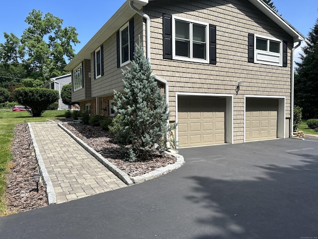 view of home's exterior featuring driveway and an attached garage