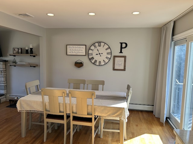 dining room featuring a baseboard radiator, visible vents, light wood finished floors, and recessed lighting