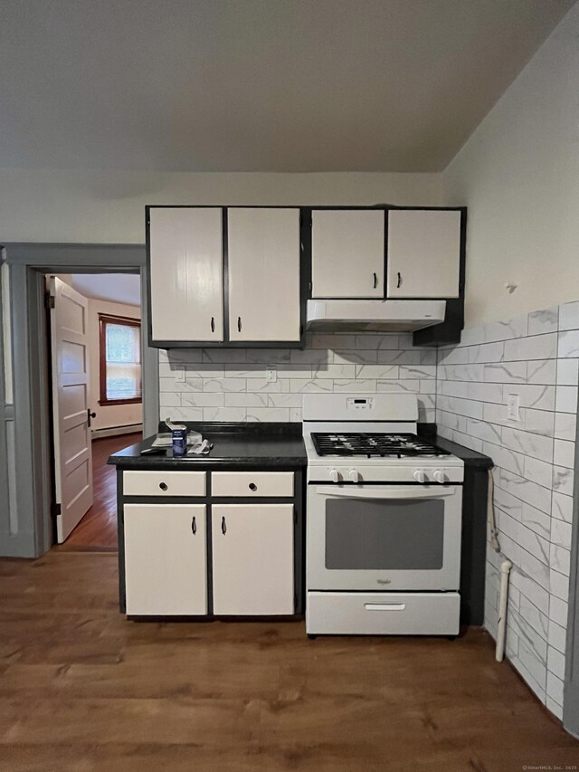 kitchen with dark wood-type flooring, backsplash, white gas range oven, and white cabinets