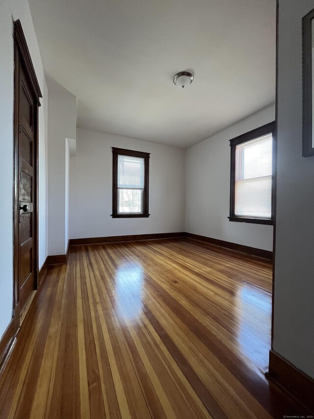 unfurnished room with dark wood-type flooring