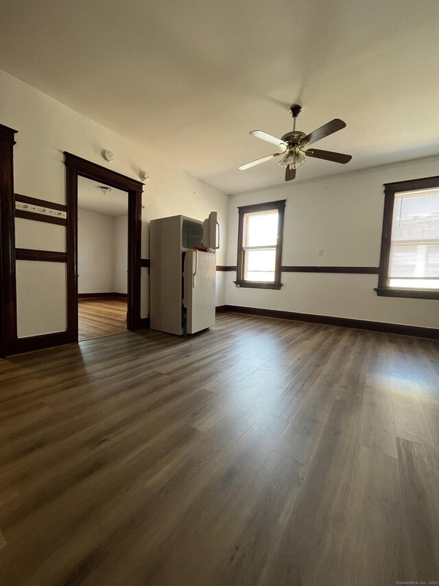 unfurnished room featuring ceiling fan and dark hardwood / wood-style flooring