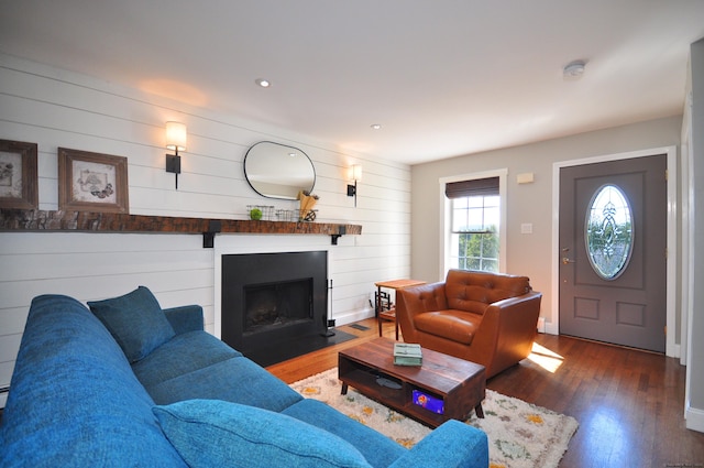 living area with a fireplace with flush hearth, wood finished floors, and recessed lighting