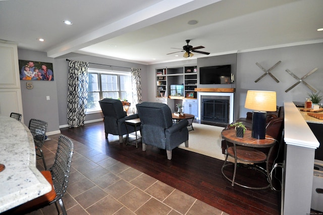 living area with baseboards, a ceiling fan, dark wood-style flooring, a fireplace, and recessed lighting