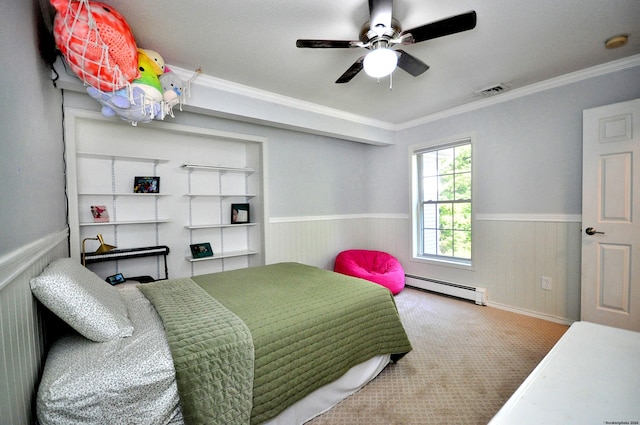 carpeted bedroom with crown molding, visible vents, a baseboard heating unit, a ceiling fan, and wainscoting