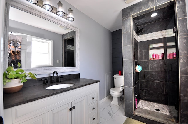 bathroom with marble finish floor, a stall shower, vanity, and toilet